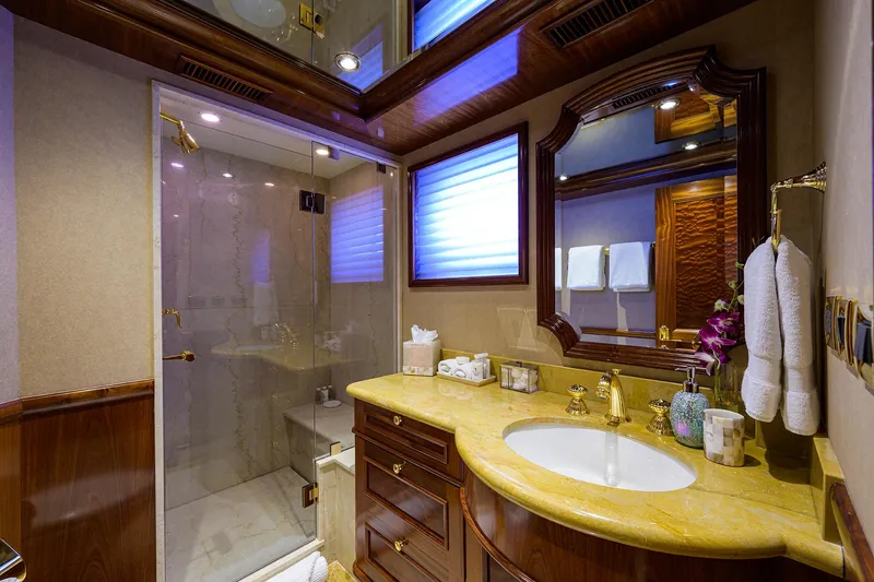 Excellence Yacht Photos Pics Luxurious bathroom on 2010 Richmond Yachts 150, featuring elegant wood and marble finishes.