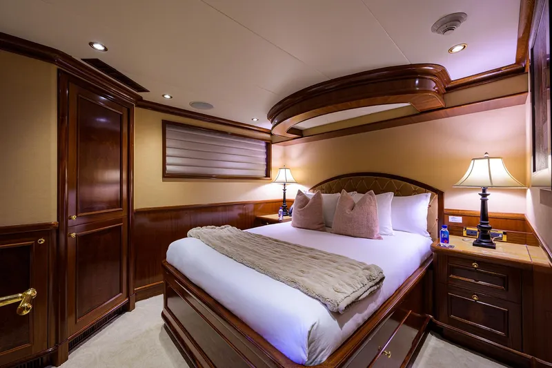 Excellence Yacht Photos Pics Luxurious bedroom interior on 2010 Richmond Yachts 150, featuring elegant wood finishes and ambient lighting.