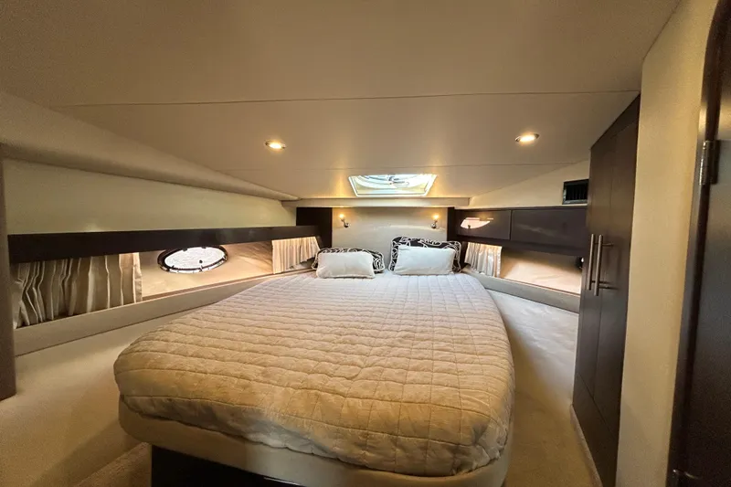  Yacht Photos Pics Luxurious cabin interior of 2018 Regal 42 Sport Coupe with cozy bed and ambient lighting.