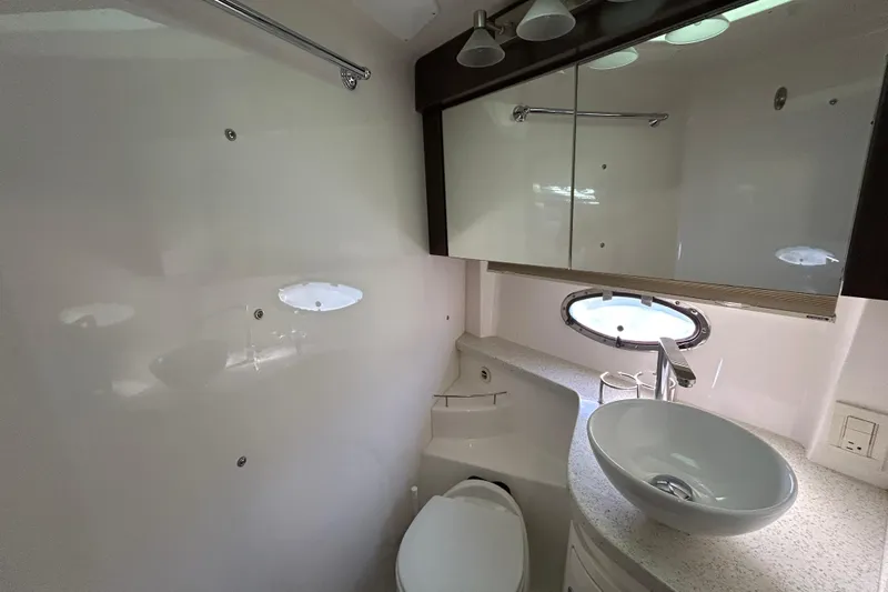  Yacht Photos Pics Luxurious bathroom in 2018 Regal 42 Sport Coupe yacht with modern fixtures and porthole window.