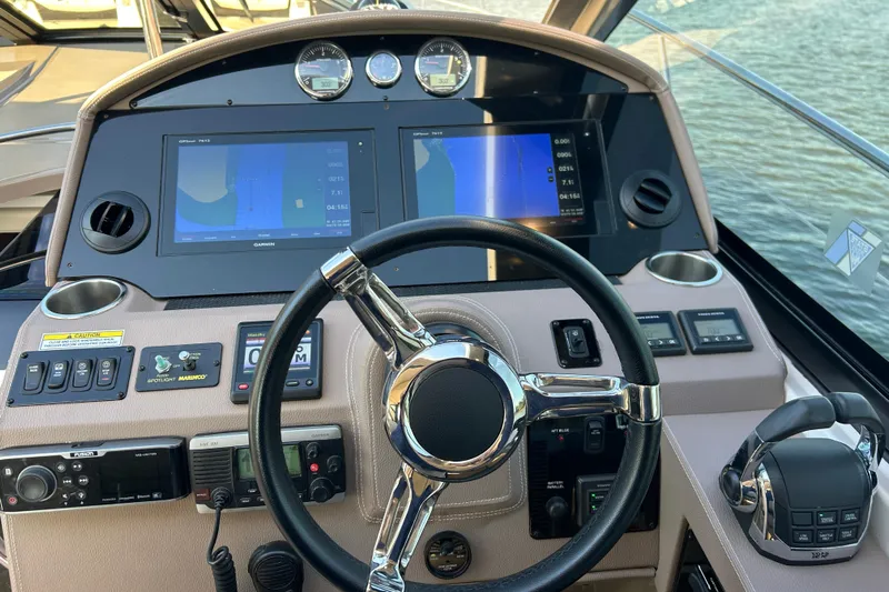 Yacht Photos Pics Control panel of 2018 Regal 42 Sport Coupe with navigation screens and steering wheel.