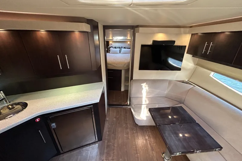  Yacht Photos Pics Luxurious interior of 2018 Regal 42 Sport Coupe with modern kitchen and cozy seating area.