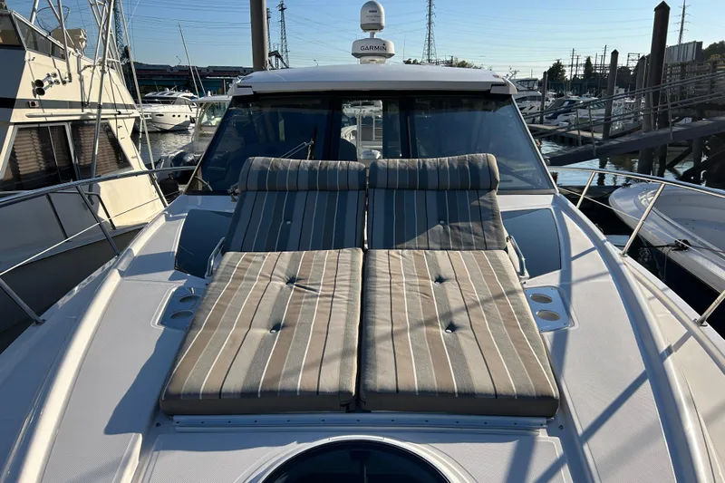  Yacht Photos Pics 2018 Regal 42 Sport Coupe yacht with striped sun loungers on deck at marina.