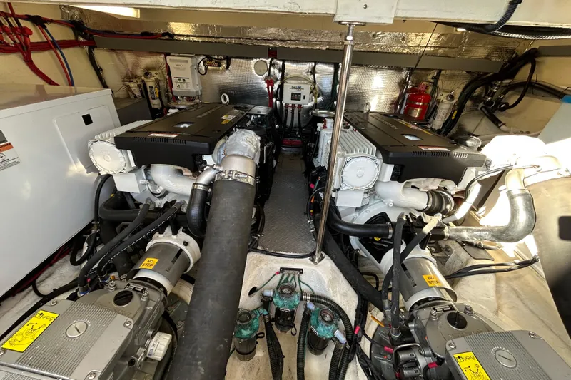  Yacht Photos Pics Engine room of a 2018 Regal 42 Sport Coupe, showcasing dual engines and mechanical components.