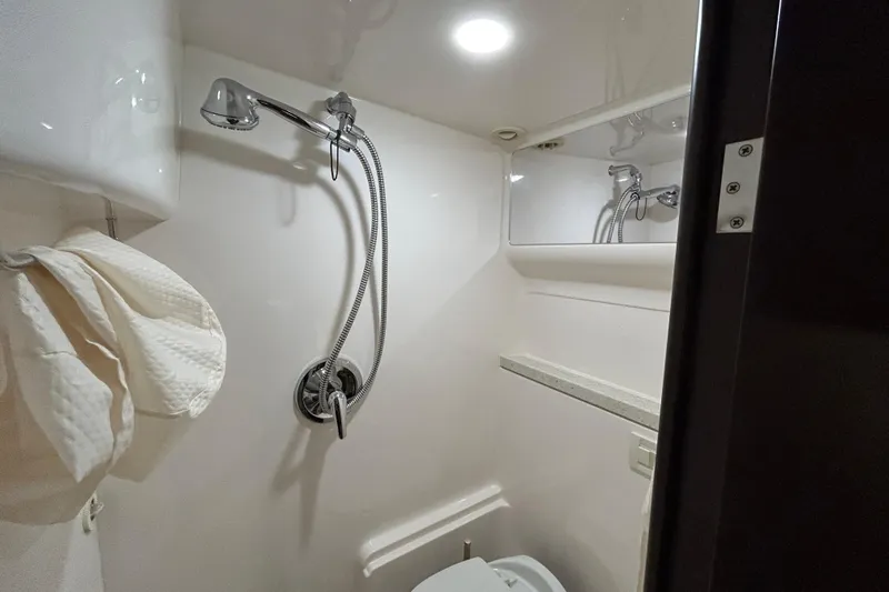  Yacht Photos Pics Bathroom interior of 2018 Regal 42 Sport Coupe yacht with shower and towel.