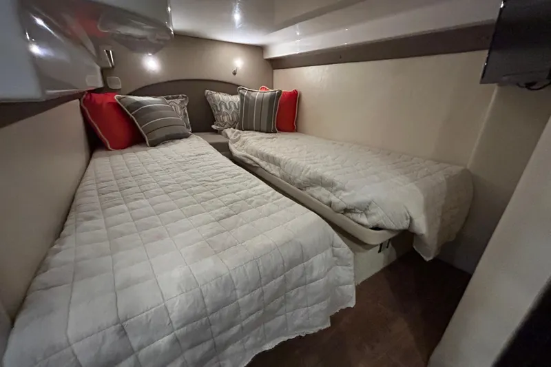  Yacht Photos Pics Interior cabin of 2018 Regal 42 Sport Coupe with twin beds and decorative pillows.