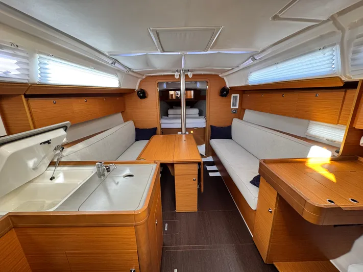  Yacht Photos Pics Interior of 2021 Dufour 360 sailboat with wood finish and cozy seating area.
