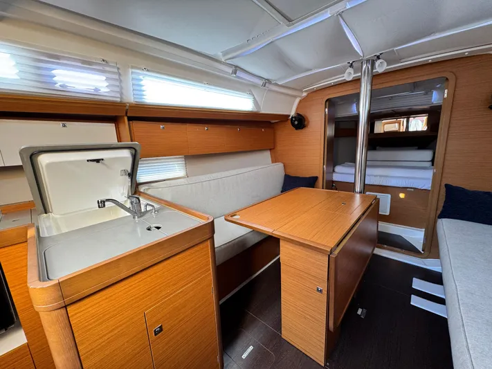  Yacht Photos Pics Interior of 2021 Dufour 360 yacht with kitchen and seating area.
