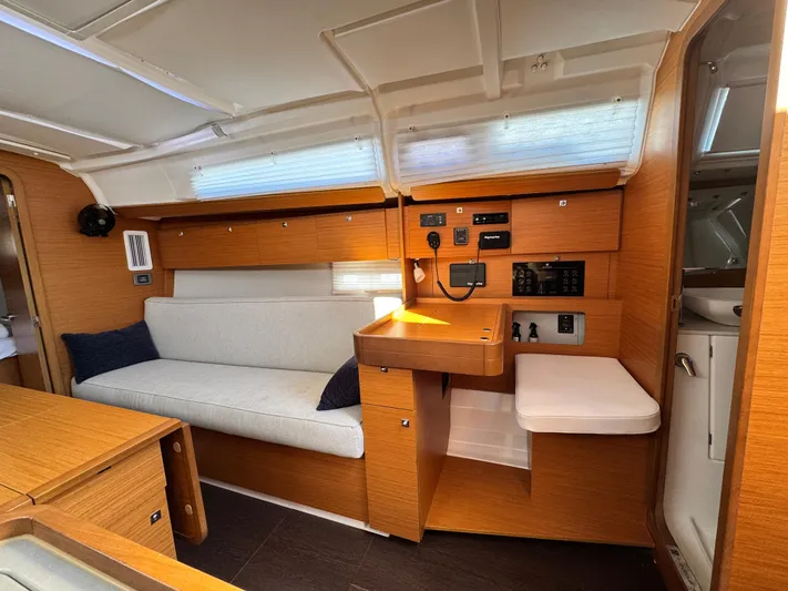  Yacht Photos Pics Interior of 2021 Dufour 360 sailboat with modern wood finish and cozy seating.