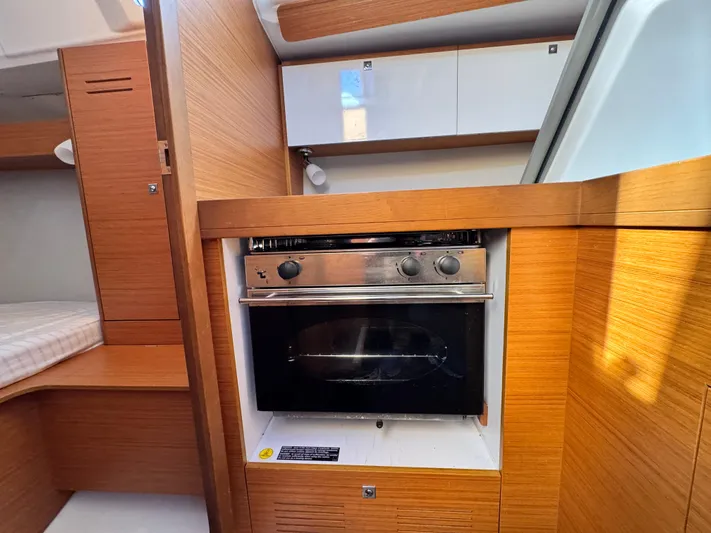  Yacht Photos Pics 2021 Dufour 360 yacht interior with modern kitchen and wood finish.
