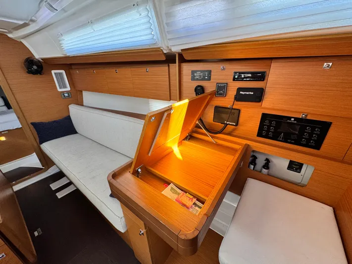  Yacht Photos Pics Interior of 2021 Dufour 360 yacht with wooden finish and navigation station.