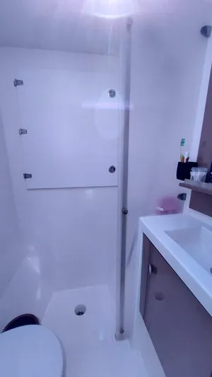  Yacht Photos Pics Bathroom interior of 2018 Fountaine Pajot Saona 47 catamaran, featuring modern fixtures and sleek design.