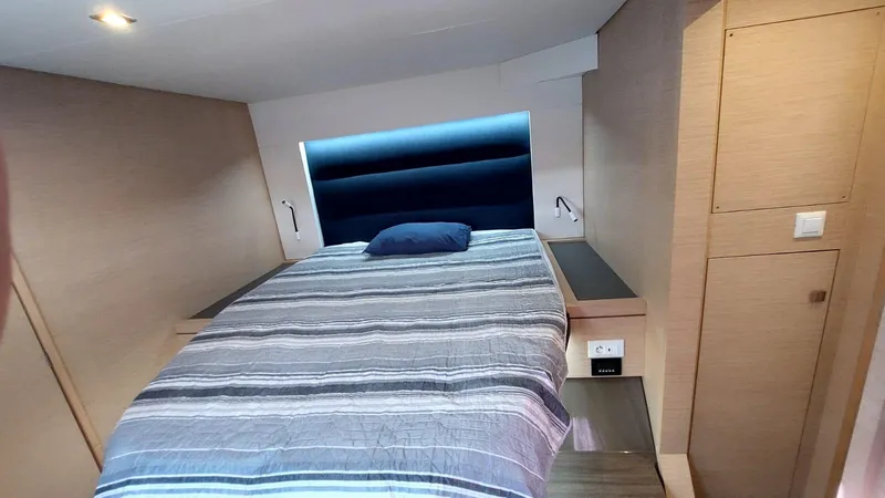  Yacht Photos Pics Cabin interior of 2018 Fountaine Pajot Saona 47 with a cozy bed and modern design.