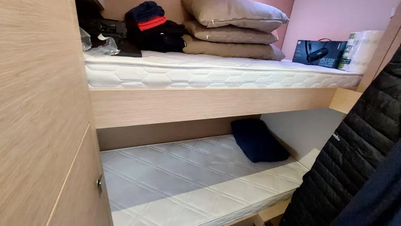  Yacht Photos Pics Bunk beds in 2018 Fountaine Pajot Saona 47 yacht cabin, with pillows and folded clothes.