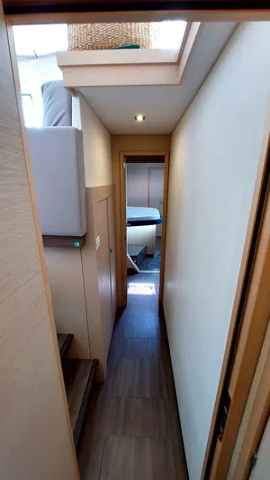  Yacht Photos Pics Narrow hallway inside 2018 Fountaine Pajot Saona 47 catamaran, featuring modern interior design.