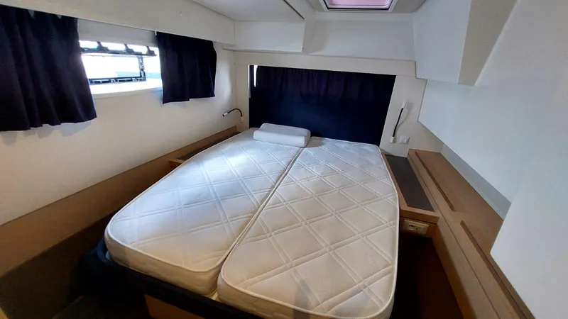  Yacht Photos Pics Cabin interior of 2018 Fountaine Pajot Saona 47 catamaran with double bed and windows.