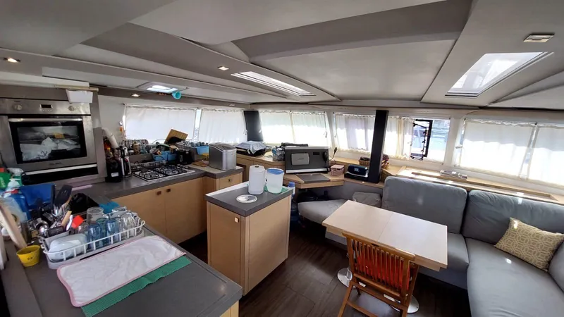  Yacht Photos Pics Interior of 2018 Fountaine Pajot Saona 47 catamaran with modern kitchen and seating area.