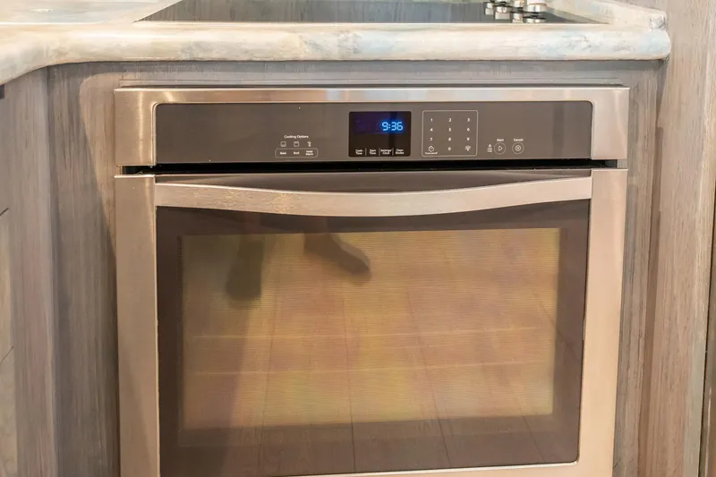 Hatt's Off Yacht Photos Pics Built-in stainless steel oven in 1998 Hatteras 74 Cockpit Motor Yacht kitchen.