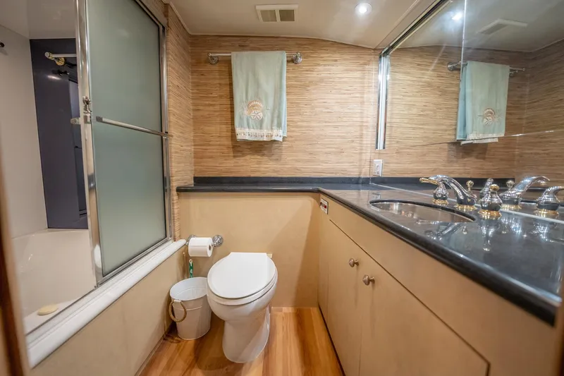 Hatt's Off Yacht Photos Pics Luxurious bathroom in 1998 Hatteras 74 Cockpit Motor Yacht with modern fixtures.