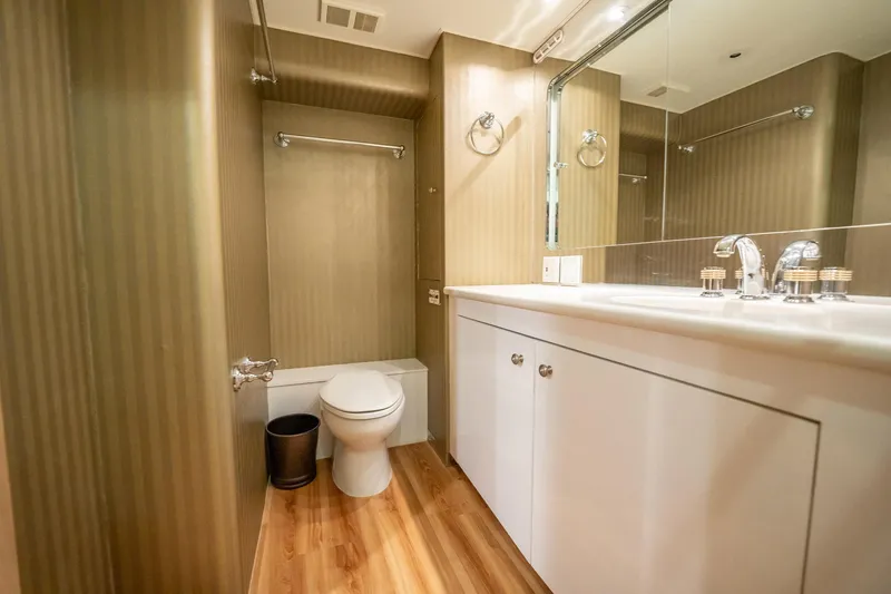 Hatt's Off Yacht Photos Pics Luxurious bathroom in 1998 Hatteras 74 Cockpit Motor Yacht with modern fixtures.