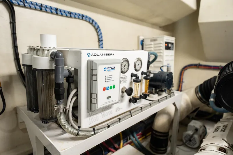 Hatt's Off Yacht Photos Pics Engine room of 1998 Hatteras 74 Cockpit Motor Yacht with Aquamiser+ water system.