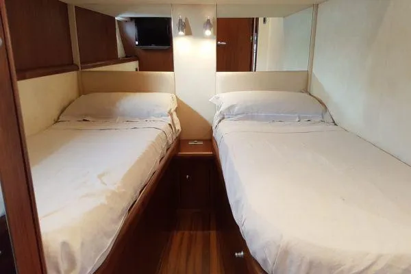  Yacht Photos Pics Twin cabin interior of 2008 Sunseeker Predator 72 yacht, featuring two beds and modern decor.