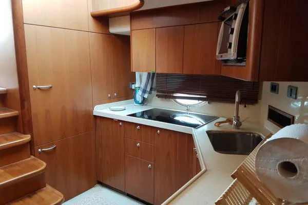  Yacht Photos Pics Luxurious kitchen interior of 2008 Sunseeker Predator 72 yacht with wooden cabinetry.