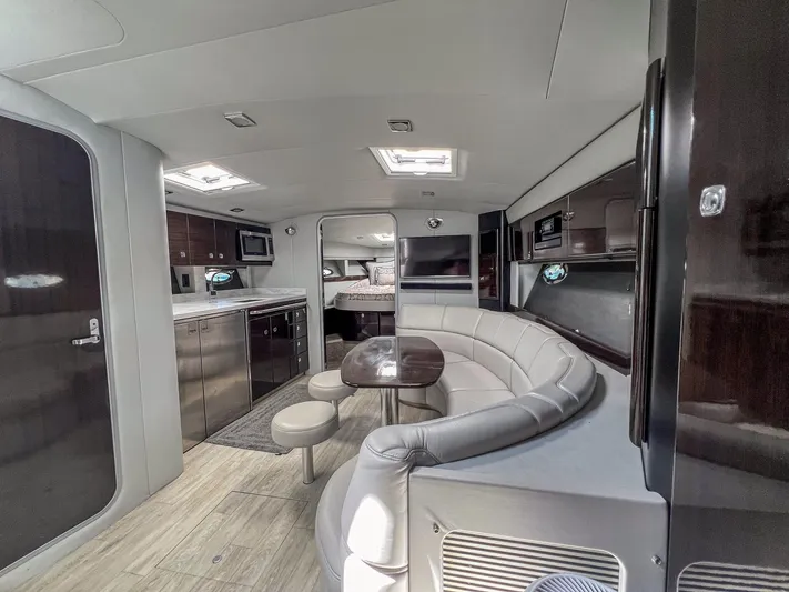Liquid Asset Yacht Photos Pics Interior of a 2017 Formula 40 PC yacht with modern kitchen and curved seating area.