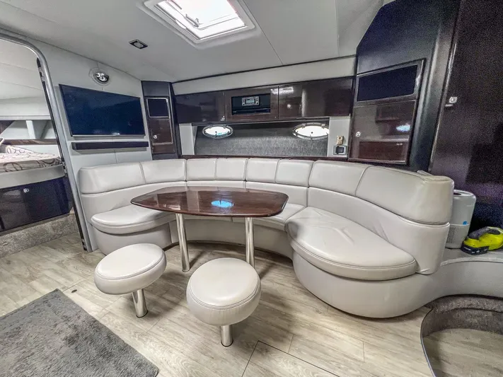 Liquid Asset Yacht Photos Pics Luxurious interior of 2017 Formula 40 PC yacht with leather seating and wooden table.