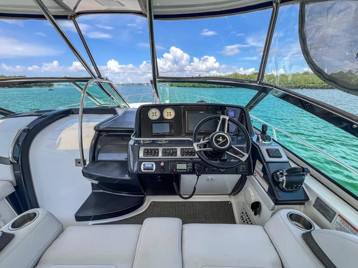 Liquid Asset Yacht Photos Pics Cockpit view of a 2017 Formula 40 PC yacht with modern controls and scenic water backdrop.