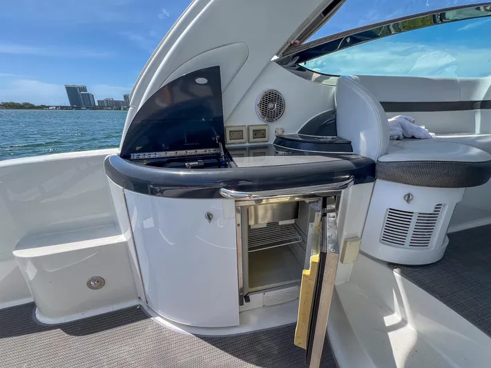 Liquid Asset Yacht Photos Pics 2017 Formula 40 PC yacht interior with open mini-fridge and waterfront view.