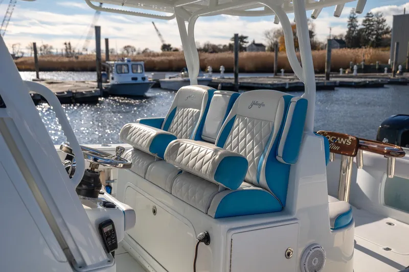  Yacht Photos Pics 2018 Yellowfin 39 Offshore boat with luxurious blue and white seating at a marina.