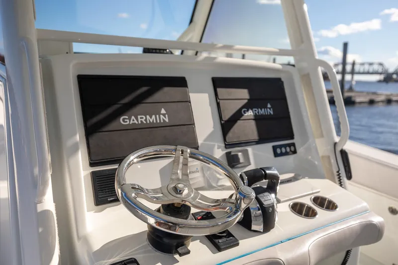  Yacht Photos Pics 2018 Yellowfin 39 Offshore boat dashboard with Garmin navigation system and steering wheel.