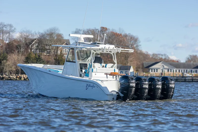  Yacht Photos Pics 2018 Yellowfin 39 Offshore boat with four powerful outboard engines on a calm waterway.