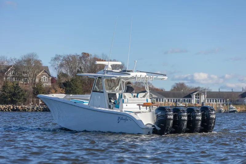  Yacht Photos Pics 2018 Yellowfin 39 Offshore boat with four powerful engines on a calm waterway.