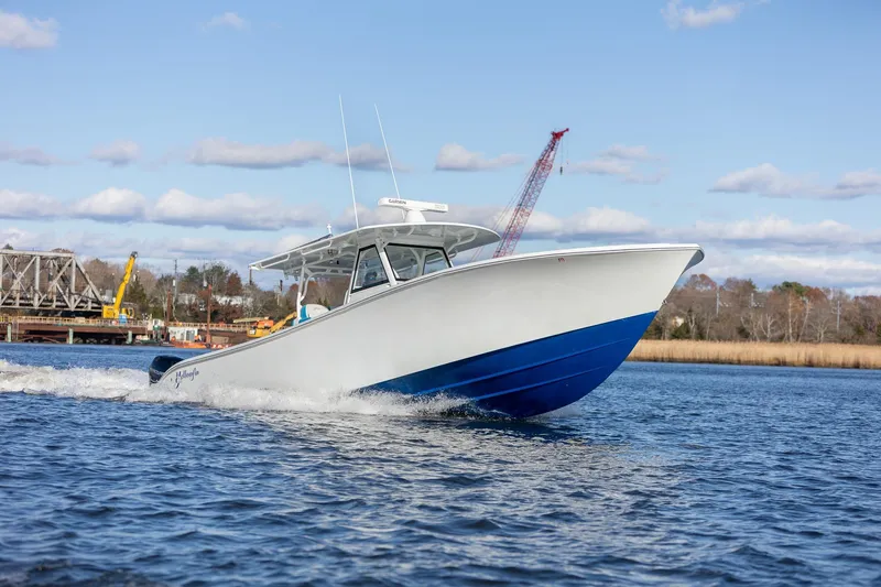  Yacht Photos Pics 2018 Yellowfin 39 Offshore boat cruising on a sunny day, blue and white design.