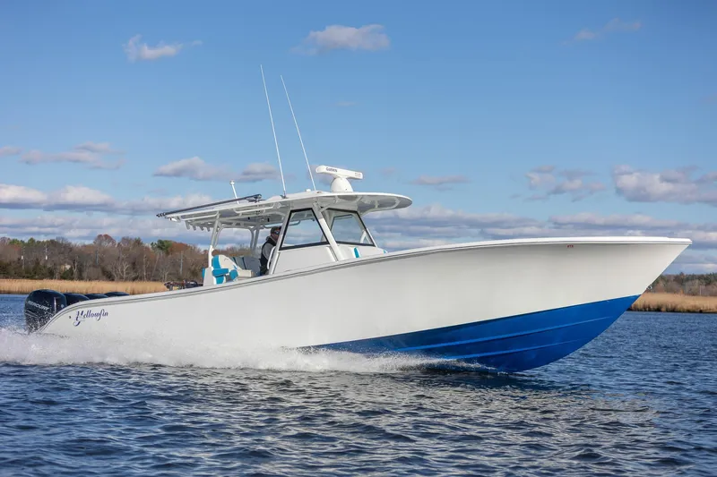  Yacht Photos Pics 2018 Yellowfin 39 Offshore boat cruising on water under clear blue sky.