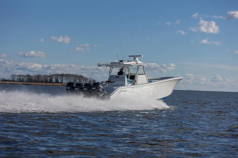  Yacht Photos Pics 2018 Yellowfin 39 Offshore boat cruising on open water under a clear blue sky.
