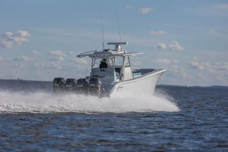  Yacht Photos Pics 2018 Yellowfin 39 Offshore boat speeding on open water under a clear sky.