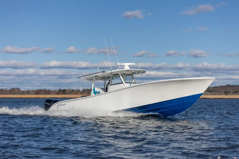  Yacht Photos Pics 2018 Yellowfin 39 Offshore boat cruising on open water under a clear blue sky.
