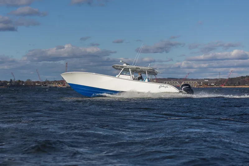  Yacht Photos Pics 2018 Yellowfin 39 Offshore boat cruising on open water under a partly cloudy sky.