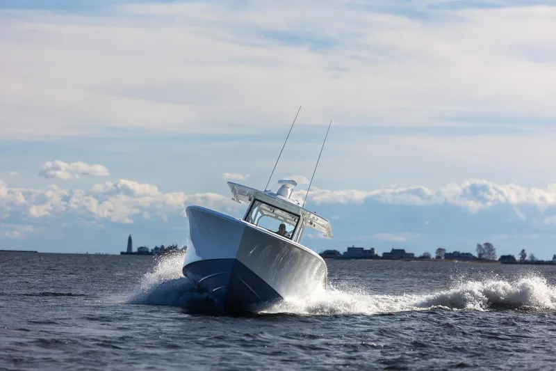  Yacht Photos Pics 2018 Yellowfin 39 Offshore boat navigating choppy waters under a cloudy sky.