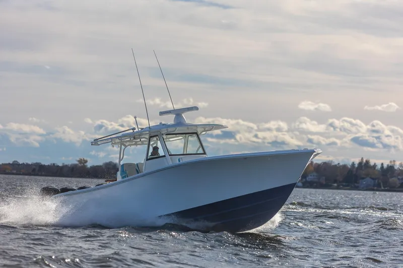  Yacht Photos Pics 2018 Yellowfin 39 Offshore boat cruising on open water under a cloudy sky.