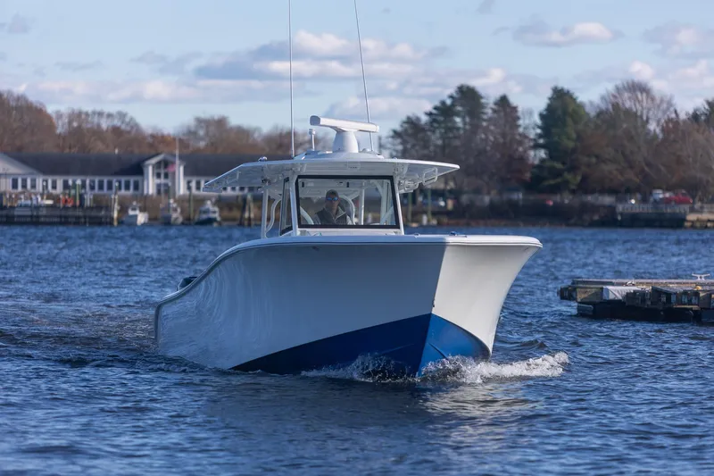  Yacht Photos Pics 2018 Yellowfin 39 Offshore boat cruising on a calm river near a marina.