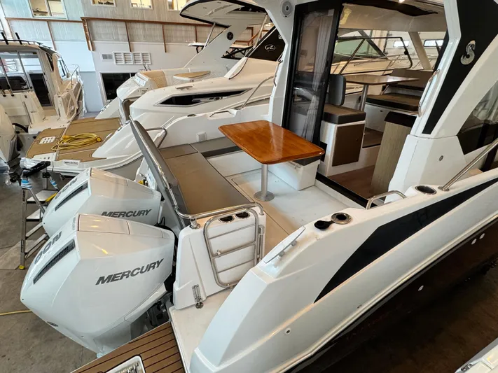 Yacht Photos Pics 2022 Beneteau Antares 9 with twin Mercury engines, featuring a spacious deck and seating area.