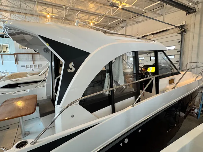  Yacht Photos Pics 2022 Beneteau Antares 9 boat in a showroom, showcasing sleek design and modern features.