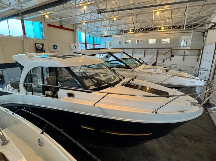  Yacht Photos Pics 2022 Beneteau Antares 9 boats displayed in a showroom.