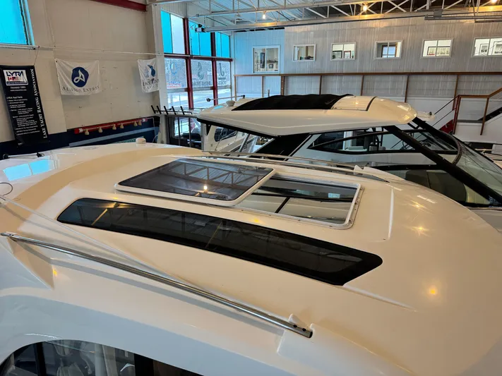  Yacht Photos Pics 2022 Beneteau Antares 9 boat roof with skylight in showroom.