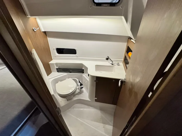  Yacht Photos Pics Beneteau Antares 9 2022 bathroom interior with toilet, sink, and storage.