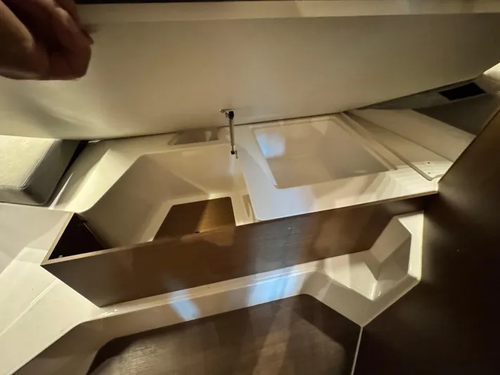  Yacht Photos Pics Interior view of 2022 Beneteau Antares 9, showcasing storage compartments and modern design.